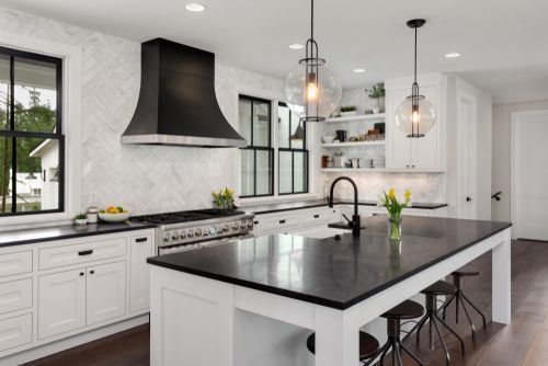 modern white kitchen cabinets with black countertops