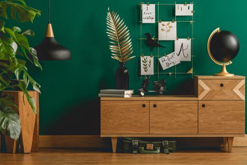 Make a unique living space with avocado green wall paint and brown cabinets