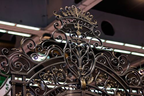 Beautify your home's entrance with a crowned head design in iron