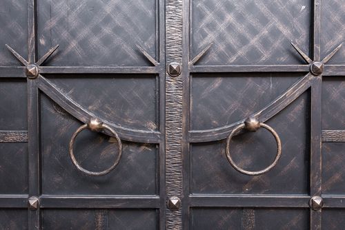 Vintage style iron door design with knocking hoops for main door