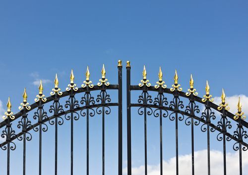 Black iron grill design with golden spear head design on top