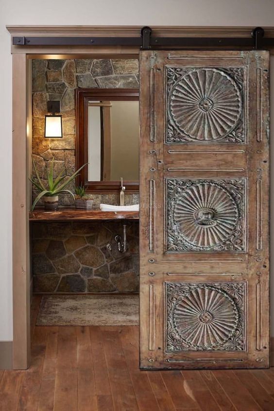 Room door design with wooden carving leading to the bathroom 