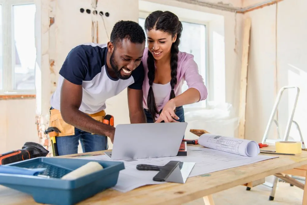 Couple viewing online home renovation loan options