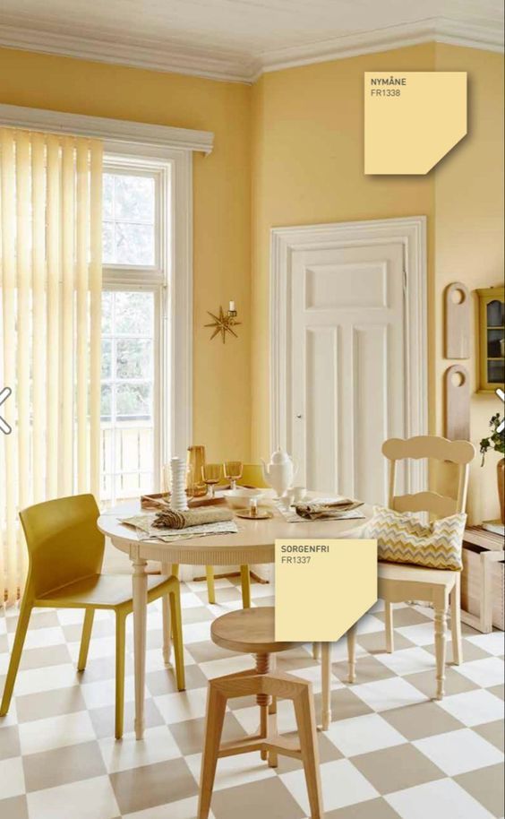 Dinner space with mustard walls, cream doors and furniture