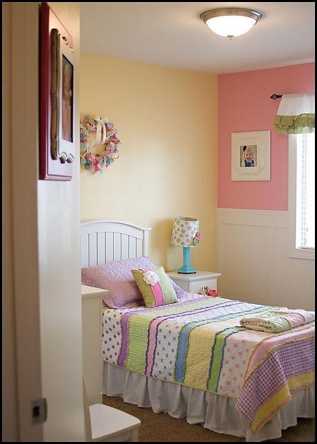 A single bedroom with pink and mustard colour wall combination