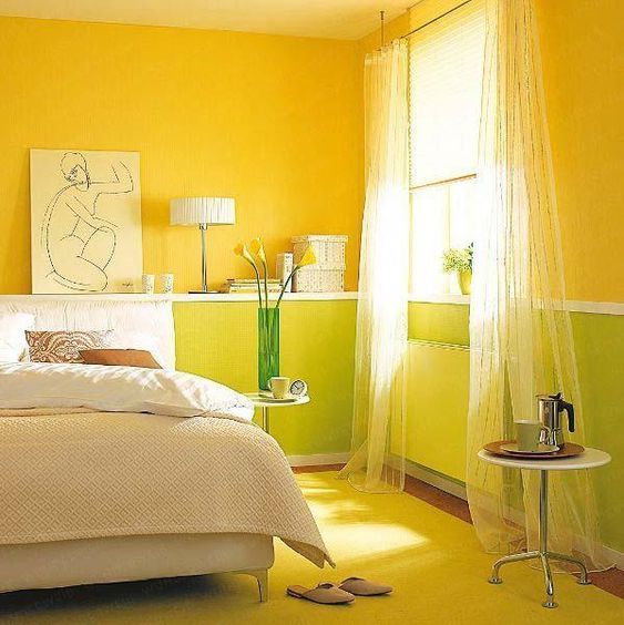 A bedroom with light green colour and vibrant yellow walls