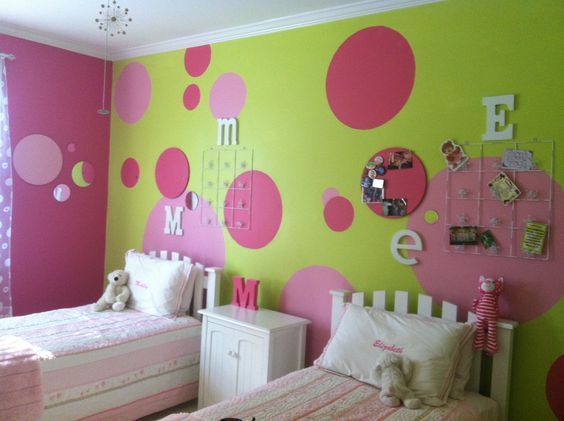 A children’s bedroom with vibrant pink and light green colours