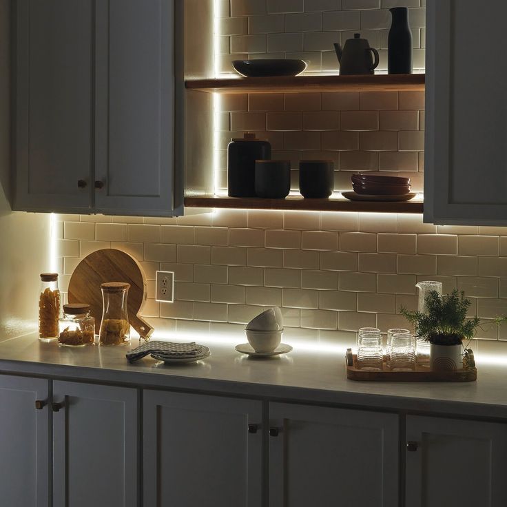 A kitchen with shelves where profile lights have been installed