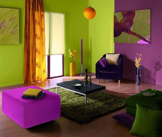 A living room in a vibrant light green colour paired with purple walls and furniture