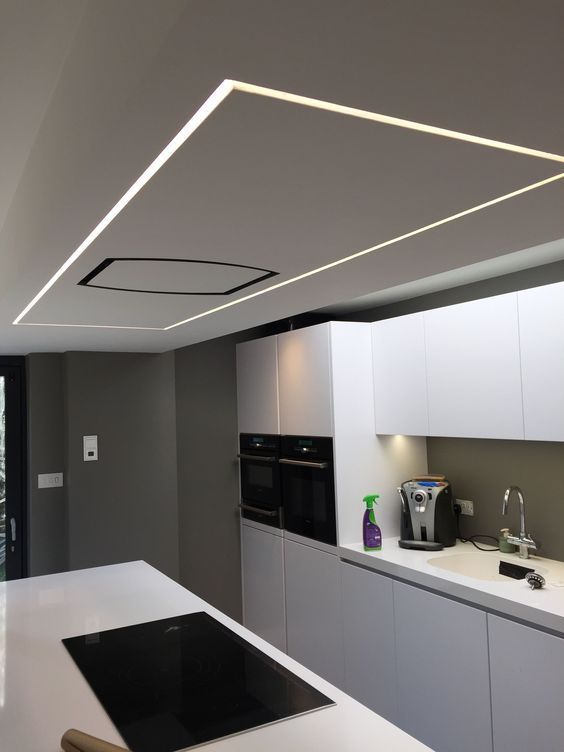 A modern modular kitchen with profile lights in the ceiling