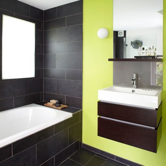 A simple bathroom in light green colour and black 