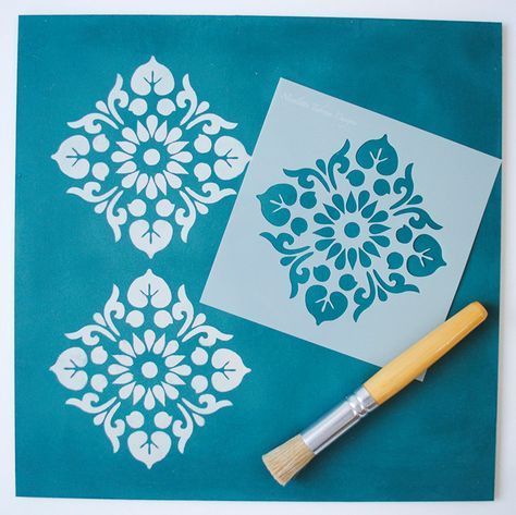 Use white spray paint on a teal base coat to get stencil flower motifs
