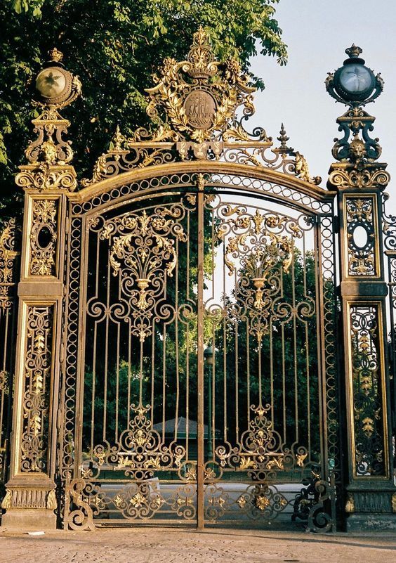 Large golden modern gate design with detailed ironwork