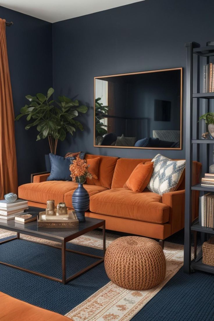 Navy blue wall paint goes well with orange sofa in the living room