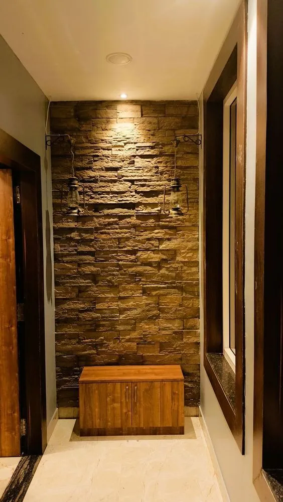 A pooja room design with a wooden cabinet and stone cladding