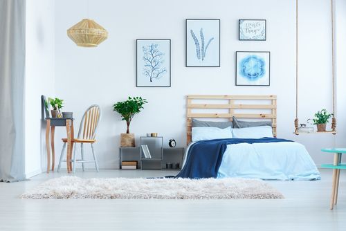 Beautify your bedroom with light blue wall paint and frames hung on them