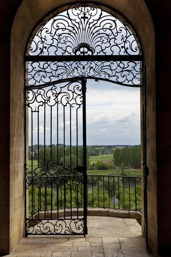 Rustic yet contemporary overhead arch iron door design