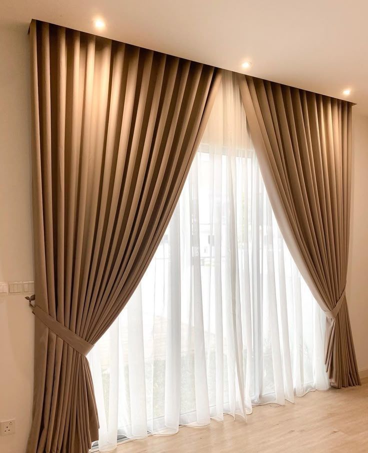 White sheer curtains with heavy beige curtains near a door