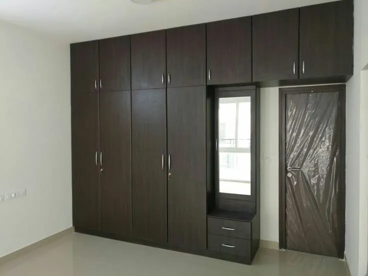 A wall almirah design with loft storage for additional storage space in a compact area