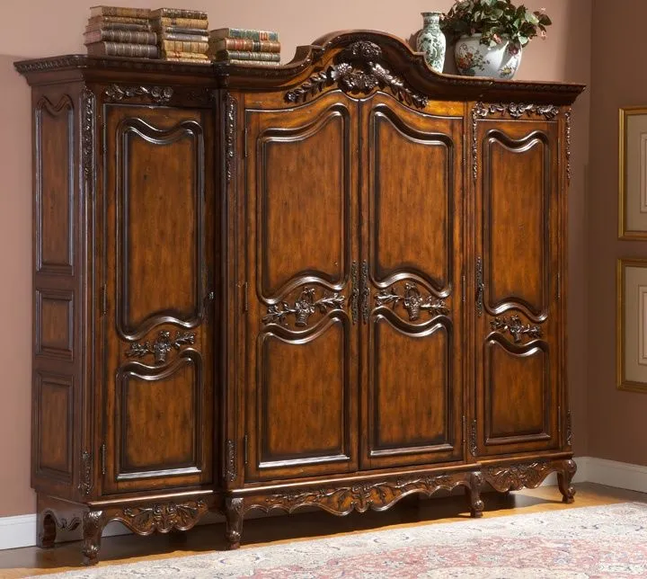 A dark brown wooden wall almirah design lending a traditional vibe to the home