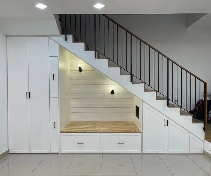A smartly customised wall almirah design to utilise a slant space under a staircase