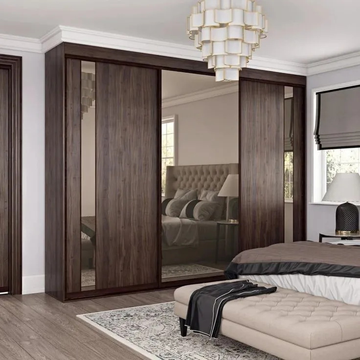 An elegant and compact wall almirah design with sliding doors and built-in mirrors