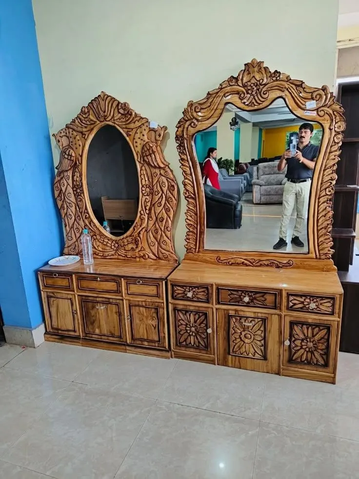 A classic wooden dressing table with ornate mirrors