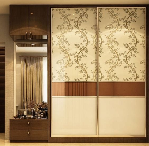 indian wardrobe design with dressing table Indian wardrobe design with patterned sliding doors and integrated study table