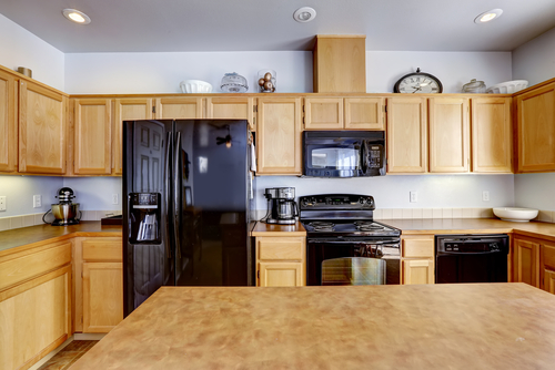 light brown kitchen cabinet with gray walls