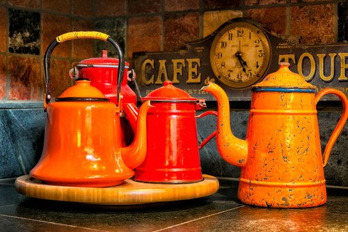 vintage-orange-red-enamel-kettles-displayed