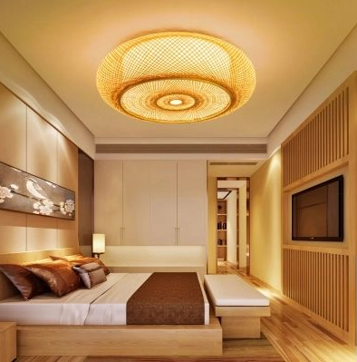 A drum-shaped ceiling bamboo light placed in a bedroom