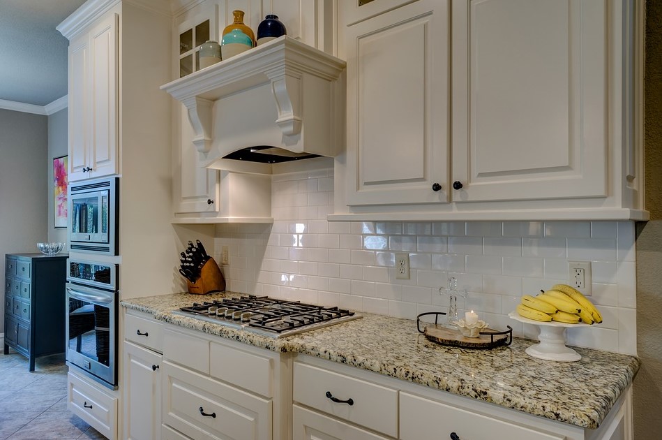 A Countertop With A Marble Kitchen Slab Paired With White Cabinets 