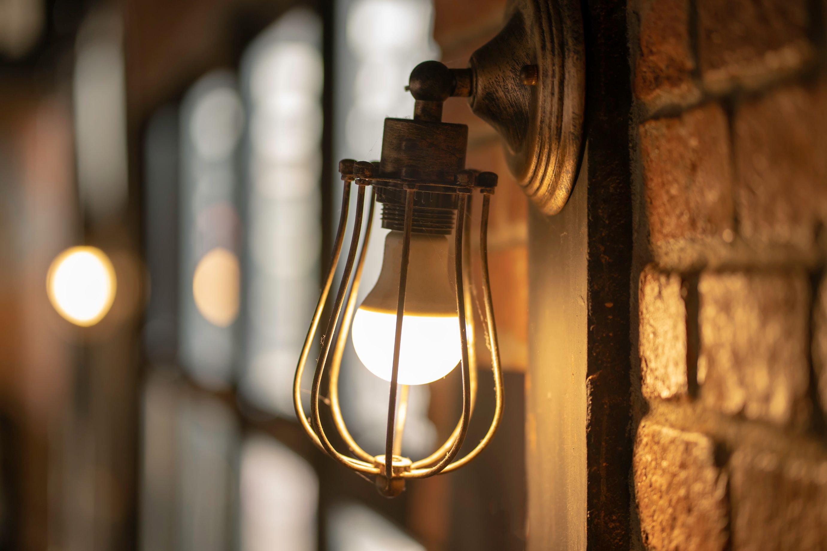 A wall light with an exposed bulb