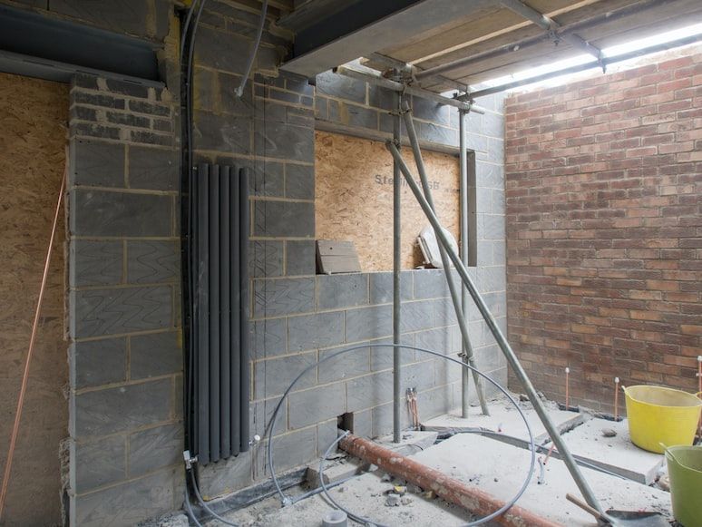 Pipes and fittings being installed in an under-construction home