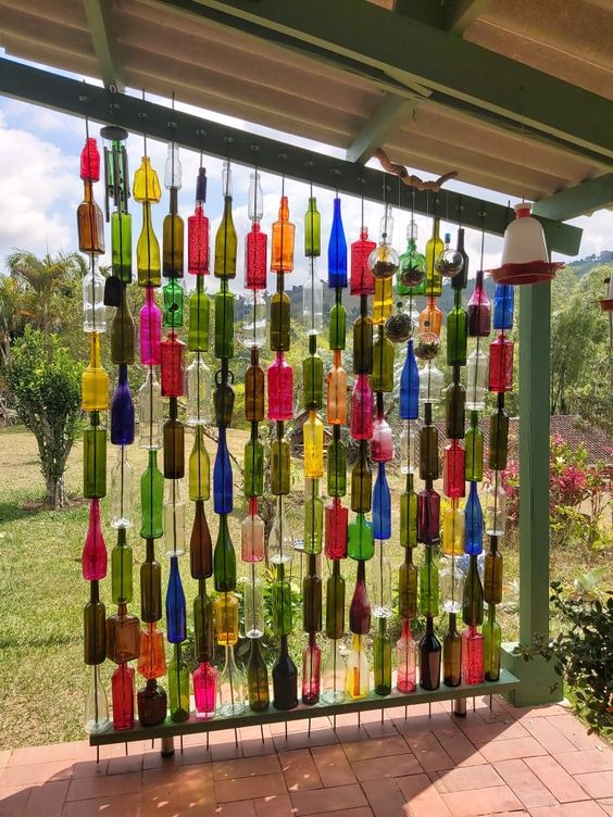 DIY room decor made using upcycled glass bottles in different colours.