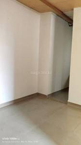 The room has white walls and a tiled floor