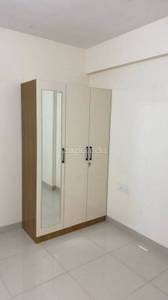 The room has a wardrobe, mirror, and socket at Sattva Park Cubix, Devanahalli, Bangalore