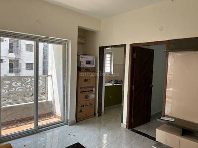 The residential apartment has an open space, kitchen area, and large windows