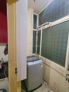 The laundry room has a washing machine, window, and door at Shashwati Nivasa, J P Nagar, Bangalore