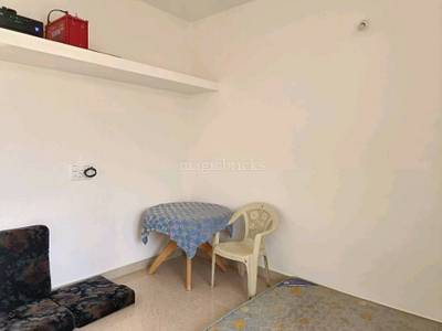 The room contains furniture, a tablecloth, chair, shelf, and electrical outlet