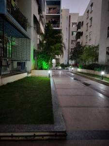 The complex buildings are near the pathway and grass at SV Brindavanam, Marathahalli, Bangalore