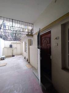 The building under construction has an open door, toilet, and stairs