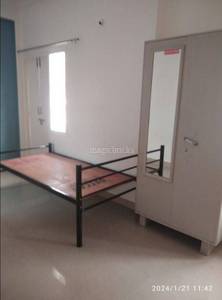 The room includes a bed, wardrobe, door, and mirror