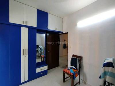 The room has a blue and white wardrobe and a wooden chair at Malibu Sparkling Wings, Marathahalli, Bangalore