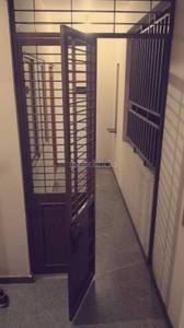 The entrance has doors that open into a corridor at Sathya Elite, J P Nagar, Bangalore