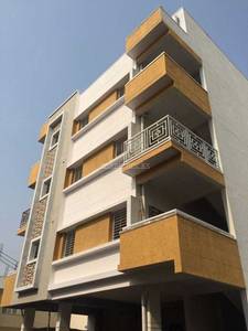 The multistory building features balconies and windows