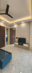 The living room has a marble floor, TV unit, and ceiling fan at Mantri Classic, Koramangala, Bangalore